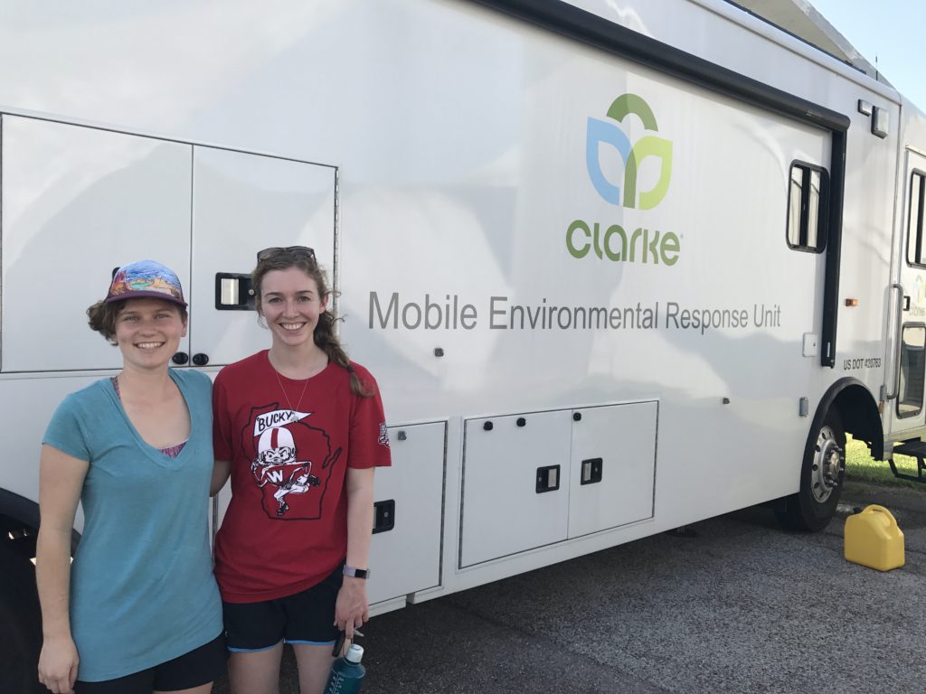 Photo of Melissa Farquhar (left) and Erin McGlynn, UW–Madison professional students, standing outside the Clarke mobile entomology lab, where they are working to identify mosquitoes to assist mosquito-control efforts following Hurricane Harvey. (Photos courtesy Erin McGlynn and Melissa Farquhar)