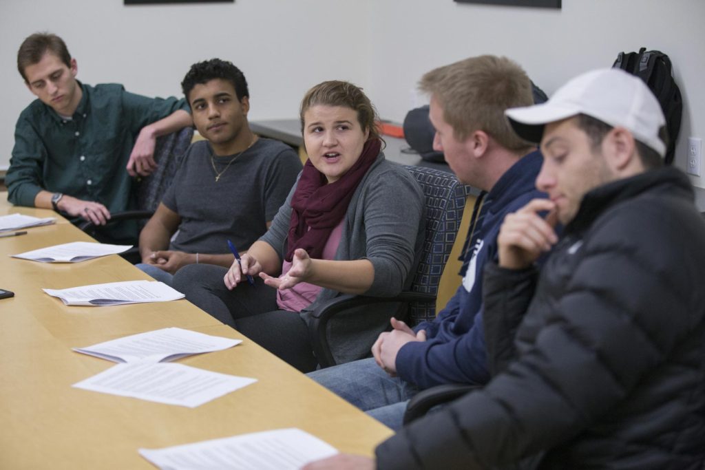 Photo of (from left) students Ron Tittle, Alexandre Vieira, Taylor Griffith, Mark Ellis and Alejandro Esquivel, practicing their discussion and analysis of economic indicators in a classroom at Hyland Hall on Monday, November 20, 2017.
