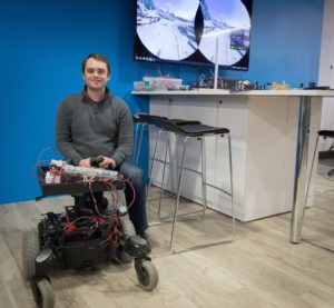 Photo of Leo Skadden, a UW-Stevens Point student, working with a robot at Sentry IT Co-op.