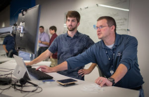 Photo of Matt Kleine (left), who was among the first to begin working at the Sentry IT Co-op with manager Steve Fox. A December graduate of UW-Stevens Point, Matt is now a full-time associate with Sentry Insurance.