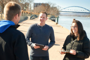 Photo of Assistant Professor of Recreation Management Daniel Plunkett, center, who is the director of the UW-La Crosse Tourism Research Institute.