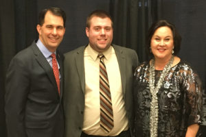 Photo of UW-La Crosse Senior Mark Davis, center, with Wisconsin Gov. Scott Walker, left, and Stephanie Klett, secretary of the Wisconsin Department of Tourism at the Wisconsin tourism convention. Davis is currently getting hands-on experience as an intern with the Fond du Lac Area Convention & Visitors Bureau. He recently returned from the state tourism conference excited and with greater insight into tourism.