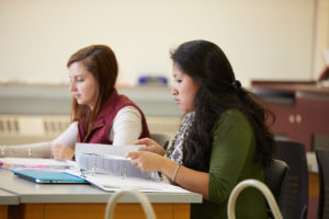 Photo of UWL student researcher Jaycelin Chan, right, who became interested in the research project after taking a course with Leslie Rogers where the class interviewed teachers and parents of students with disabilities. After helping transcribe notes, she was intrigued by thoughts from both parents and teachers about communication and collaboration in the classroom.