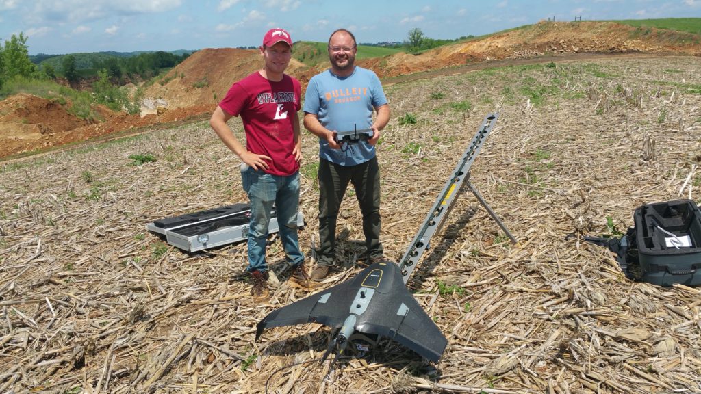 Photo of Jackson Radenz, with help from his research mentor, Niti Mishra, Geography and Earth Science, and Doug Kerns, a city of La Crosse employee, are using drones to survey a quarry in La Crescent. Kerns returned to UWL in 2014 to complete his degree. Geography courses opened him up to the potential of using drone technology in his work for the City of La Crosse. Here Radenz stands with Kerns, right.