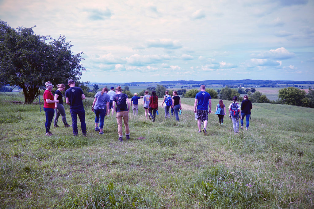 Photos of students walking in a pasture in Dunn County to learn more about the soils and farming in the area. The LAKES REU students shared their summer research on Aug. 8 in Menomonie, and Aug. 10 in Chetek.