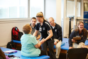 Photo of UWL students working with Parkinson’s patients during their physical therapy coursework. Clinical and service opportunities that engage students and faculty in research and the community was a key for re-accreditation from the Commission on Accreditation in Physical Therapy Education.