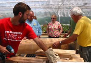 Mike Geiger (left) at a hydroponic salad table workshop at the greenhouse. All photos courtesy of Mike Geiger.
