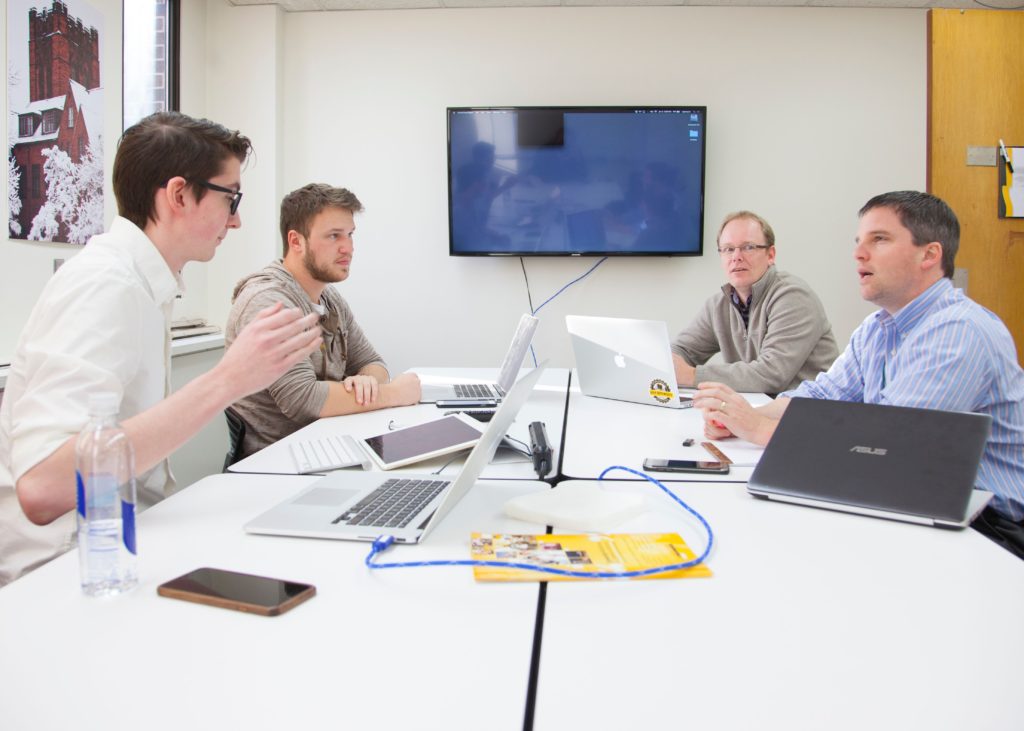 Photo of students in UWM’s App Brewery working with doctors at the Medical College of Wisconsin to develop an app that helps guide doctors during the delicate process of brain surgery.