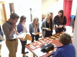 Photo of students doing a poverty simulation as part of the Wisconsin Express program, helping illustrate some of the difficult choices people in poverty face. COURTESY OF AHEC