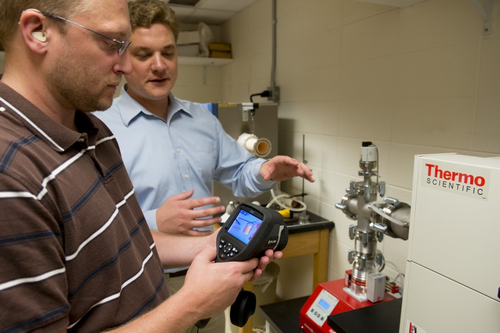 student and professor working with superconductor technology