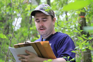 biology student gathers data on clipboard