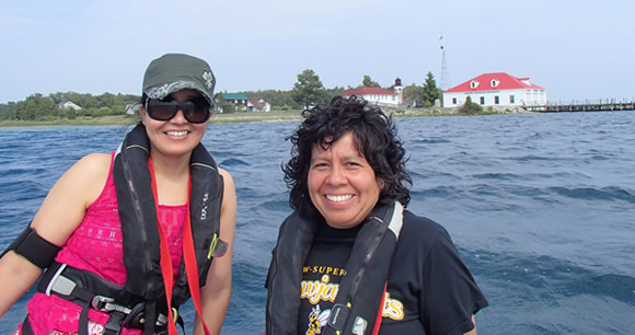 professor and student on a boat off the coast of Michigan
