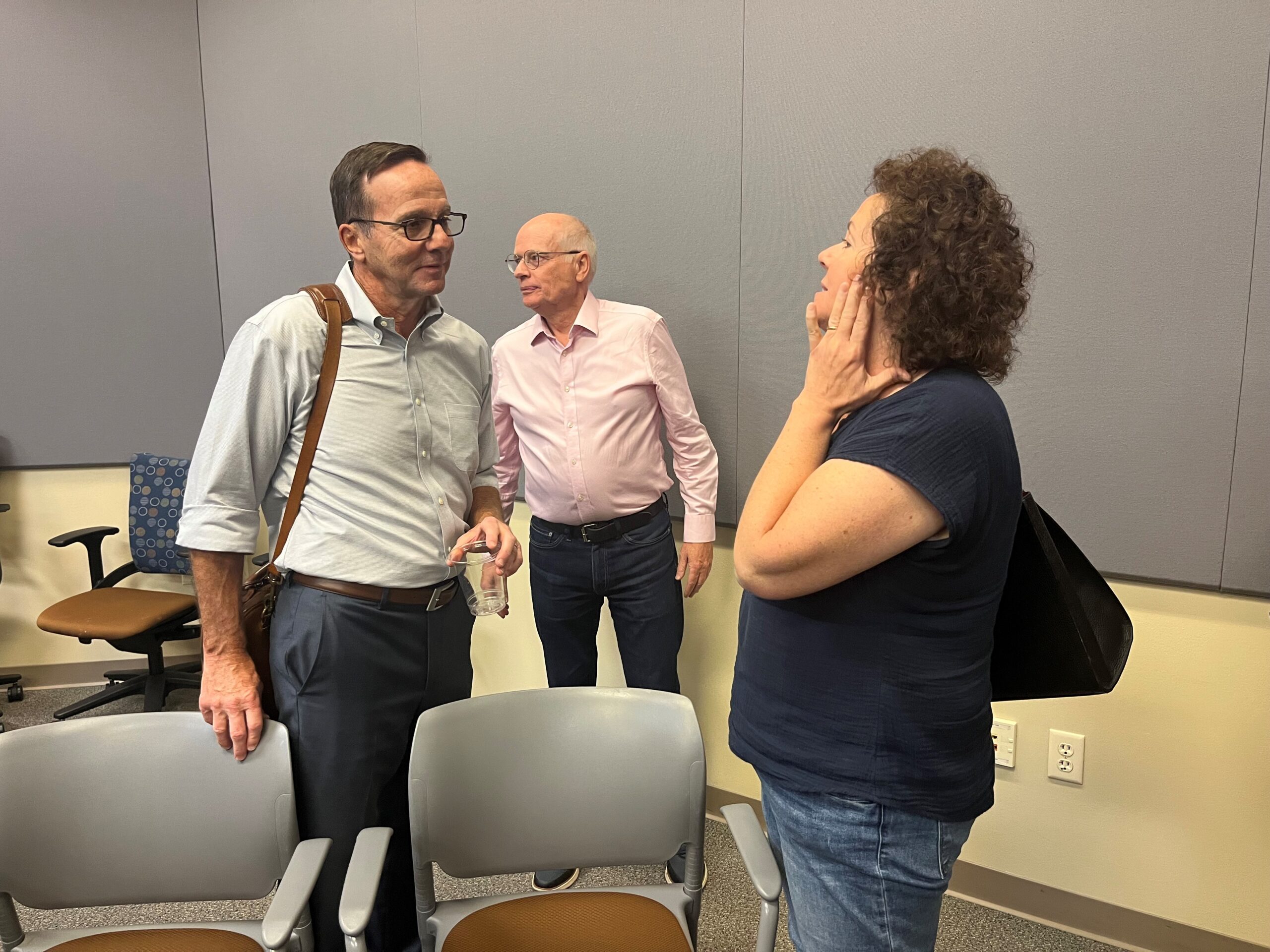 Stephen Schmid of UWSA listens to UW-Milwaukee faculty representative Kathleen Dolan after the September 20 meeting