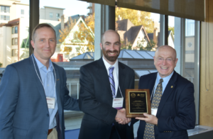 Dr. James Kabrhel receives his award from President Cross