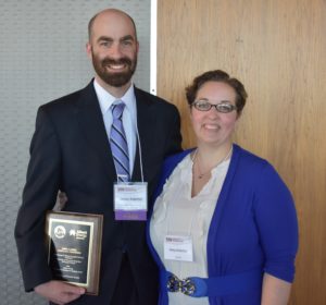 James Kabrhel and his wife smiling with his award.