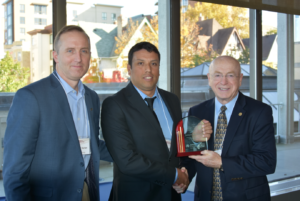 Julian Rodriguez receives his award from President Cross