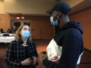 Regent Amy Bogost and Brandon Pope, a UW-Whitewater student, talk after the December 2021 University of Wisconsin System Board of Regents Education Committee presentation on the Math Initiative.