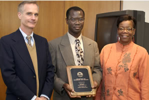 Department Chair Benjamin Ofori-Amoah and Professor David Ozsvath receive the 2003 teaching award on behalf of the UW-Stevens Point Department of Geology and Geography from Regent Danae Davis.