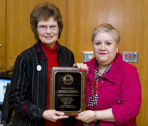 Irma Burgos receiving award from Regent Crain