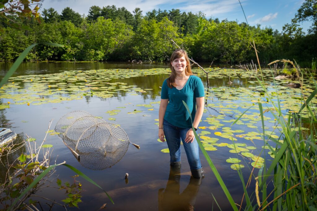 Student standing in a river