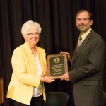 Prof. Mark Bergland, department chair of UW-River Falls Department of Biology, accepts award from Regent Farrow