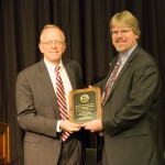 Clifton Ganyard (right), UW-Green Bay, accepts award from Regent Pruitt