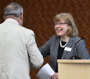 Photo of departing Executive Director and Corporate Secretary Jane Radue greeting Regent Jose Delgado