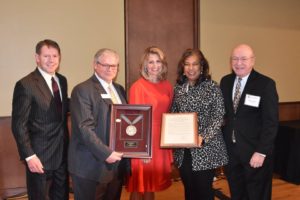 Photo of Regent Emerita Lisa Erickson (center) receiving a resolution of appreciation for her service on the Board of Regents. Also pictured (from left): Regent President John Robert Behling, Regent Mark Tyler, Regent Eve Hall, and President Ray Cross. (Photo by Ethan Schuh)/UW System