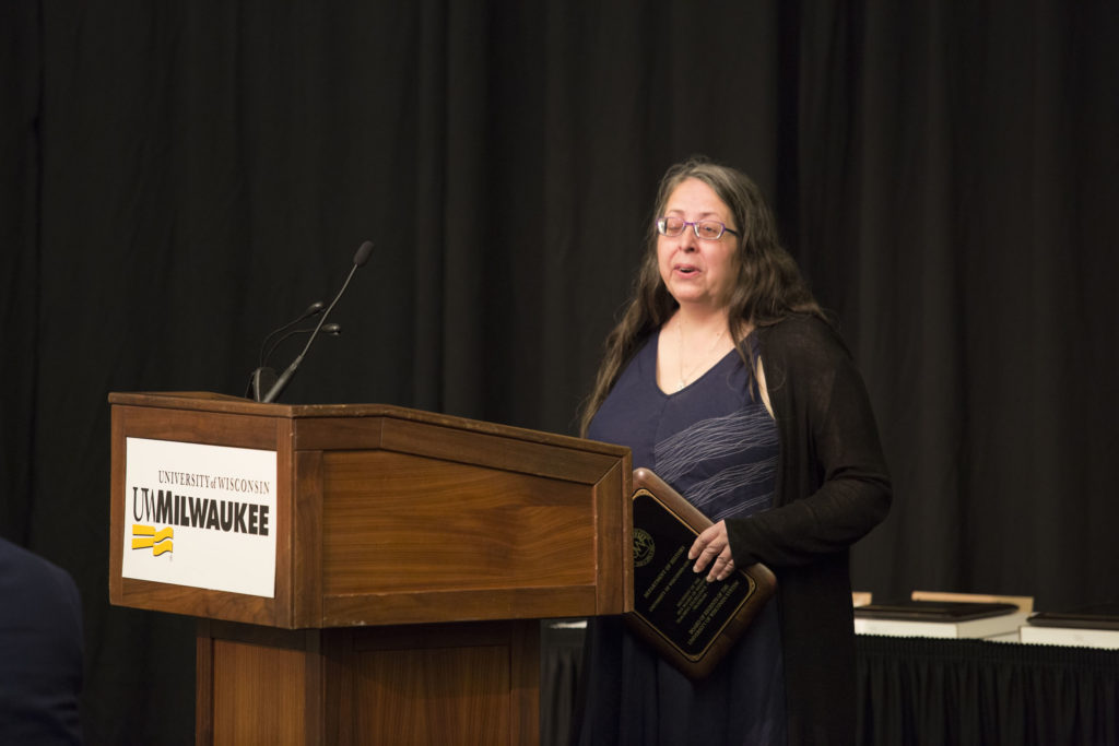 Photo of Professor Heidi Sherman accepting the 2018 Regents Teaching Excellence Award on behalf of UW-Green Bay's History Department
