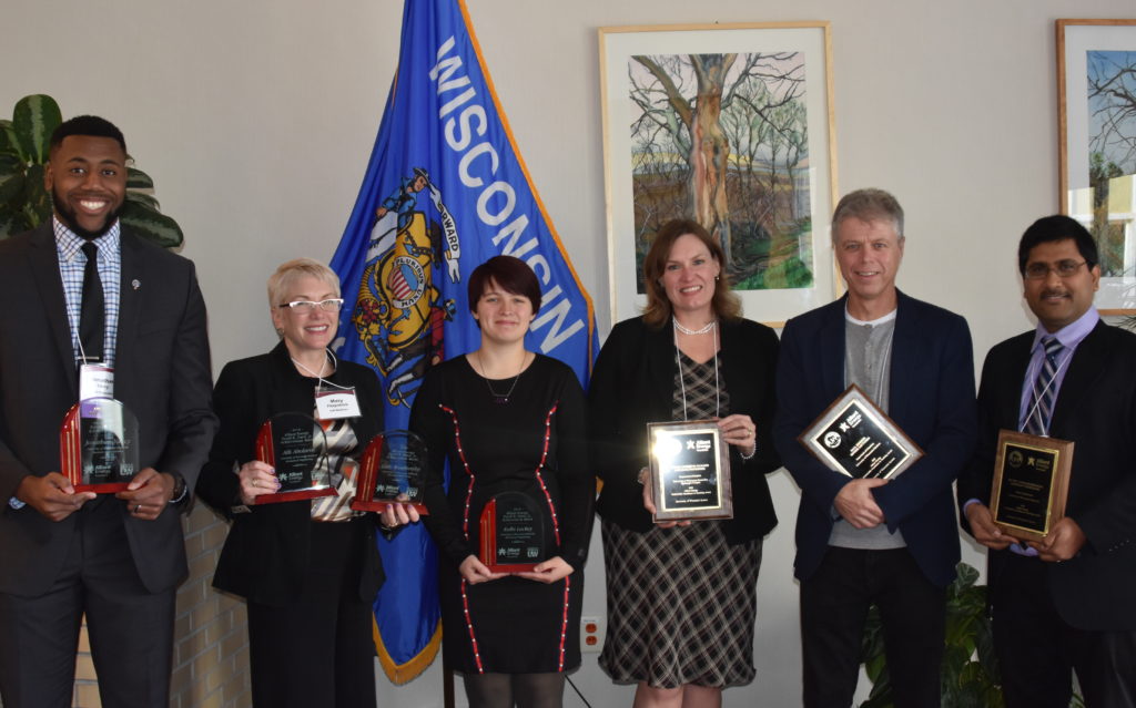 Photo of (from left) Jonathan Yancy; UW-Madison Director of Diversity Research and Initiatives Mary Fitzpatrick accepting the Alliant Energy/Erroll B. Davis, Jr. Academic Achievement Award on behalf of Alli Abolarin and Coty Weathersby (who are not pictured); Kolbi Lackey; Dr. Valerie Murrenus Pilmaier; Dr. Paul Hooker; and Dr. Muthu Venkateshwaran.