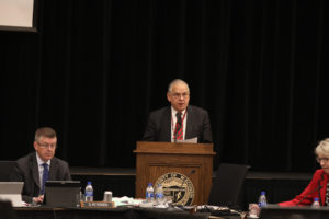 Photo of Regent José Delgado presenting UW-La Crosse a resolution of appreciation for hosting the December 6-7, 2018, Board of Regents meeting