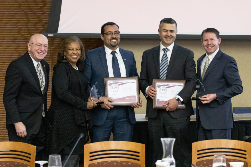 Photo of 2019 Regent Scholar co-recipients Saleh Alnaeli, assistant professor of Computer Science at UW-Stout, and Dr. Zaid Altahat, assistant professor of Computer Science at UW-Parkside (holding plaques), with (from left) President Ray Cross, Regent Eve Hall, and Regent President John Robert Behling. (Photo by Craig Wild/UW-Madison)