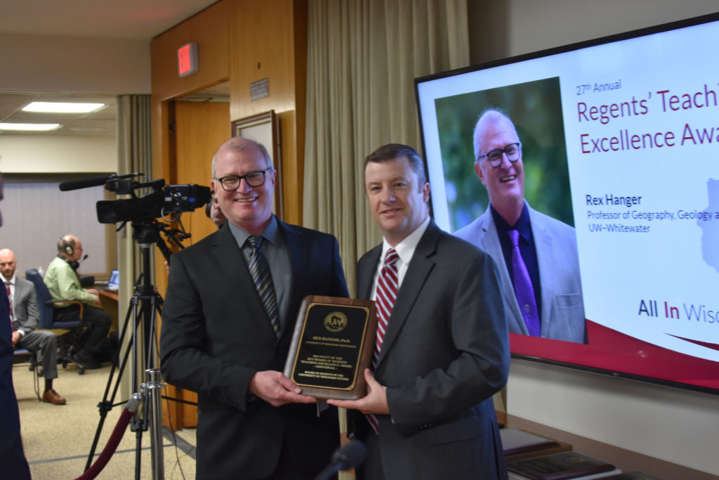 Photo of Professor Rex Hanger (left) from UW-Whitewater receiving a UW System Board of Regents 2019 Teaching Excellence Award from Regent Jason Plante at the Board of Regents meeting held in Madison on April 5, 2019.