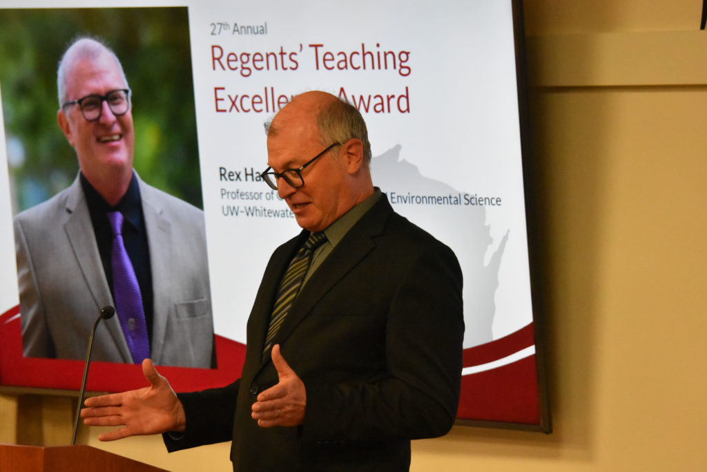 Photo of UW-Whitewater Professor Rex Hanger making acceptance remarks after receiving the 2019 Teaching Excellence Award from the UW System Board of Regents on April 5, 2019.