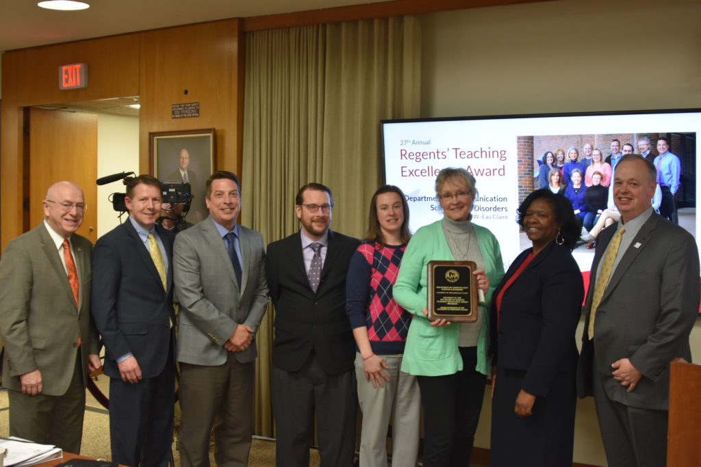 Photo of the UW-Eau Claire Department of Communication Sciences and Disorders receiving a UW System Board of Regents 2019 Teaching Excellence Award at the Board of Regents meeting held in Madison on April 5, 2019. Pictured from left: UW System President Ray Cross, Regent President John Robert Behling, Assistant Professor Tom Sather, Assistant Professor Thomas Kovacs, Associate Professor Abby Hemmerich, Department Chair Vicki Samelson, State Superintendent of Public Instruction and Regent Carolyn Stanford Taylor, and Chancellor James Schmidt.