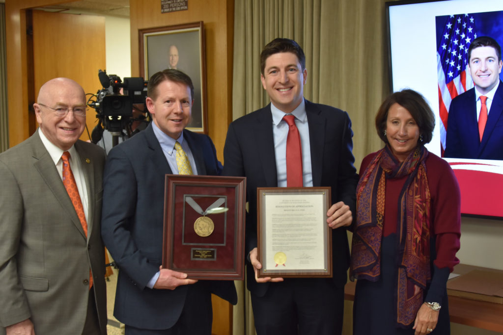 Photo of Regent Emeritus Bryan Steil (second from right), who received a resolution of appreciation for his service on the UW System Board of Regents. Also pictured (from left): UW System President Ray Cross, Regent President John Robert Behling, and Regent Tracey Klein.