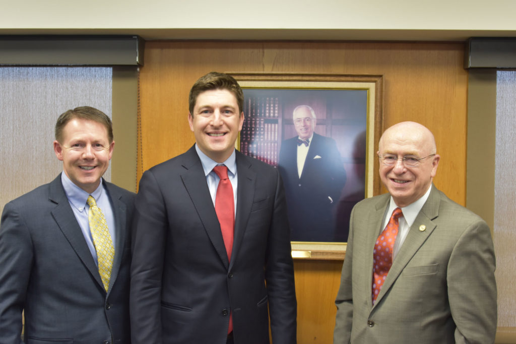 Photo of (from left) Regent President John Robert Behling; Regent Emeritus Bryan Steil; portrait of Regent Steil's grandfather, George K. Steil Sr., who served on the Board of Regents in the 1990s, including two years as Board president; and UW System President Ray Cross.