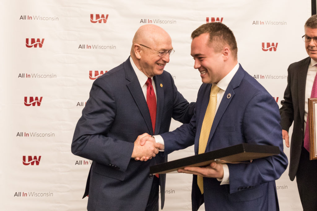 Photo of President Ray Cross congratulating Regent Emeritus Ryan Ring on his service