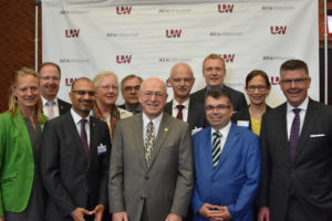 Photo of President Ray Cross, center, and Regent President Andrew S. Petersen, far right, welcoming a visiting delegation from the State of Hessen, Germany