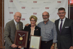 Photo of President Ray Cross, Regent Emerita Regina Millner receiving resolution of appreciation, Regent Emeritus Michael J. Falbo, and Regent President Andrews S. Petersen