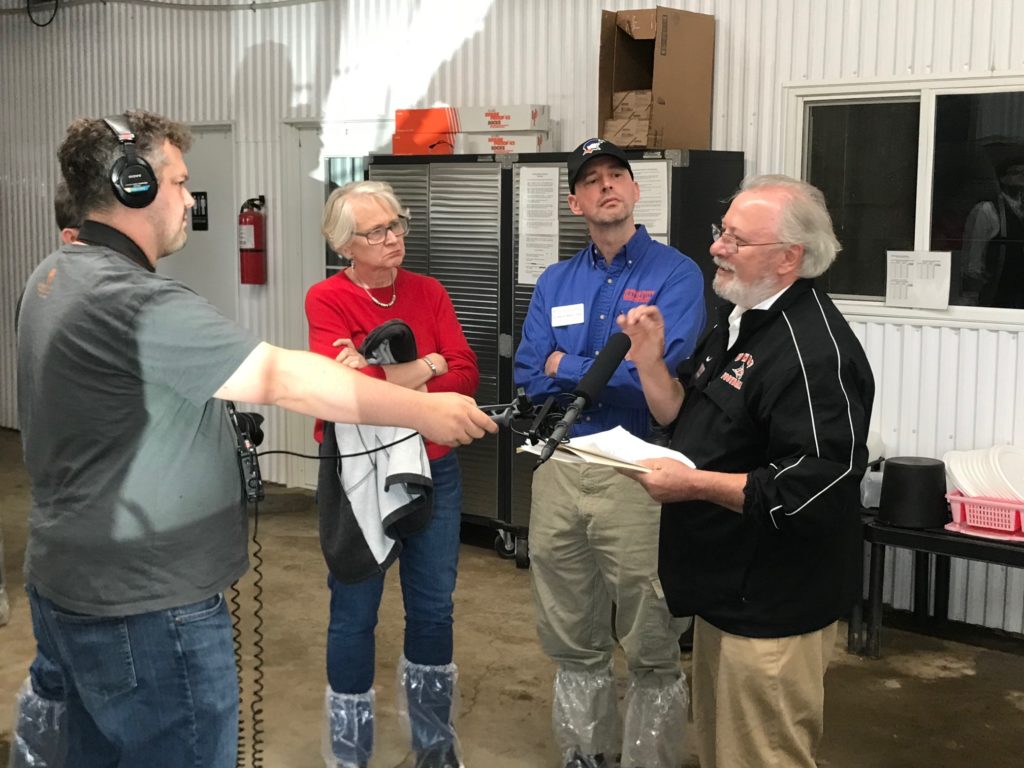 Photo of Kate VandenBosch, Dean of the College of Agricultural and Life Sciences at UW-Madison (left), Wayne Weber, Dean of the College of Business, Industry, Life Science and Agriculture at UW-Platteville (middle), and Dale Gallenberg, Dean of the College of Agriculture, Food and Environmental Sciences at UW-River Falls (right), discussing the impact of the $8.8 million Dairy Innovation Hub at a news conference at Four Cubs Farm in Grantsburg.