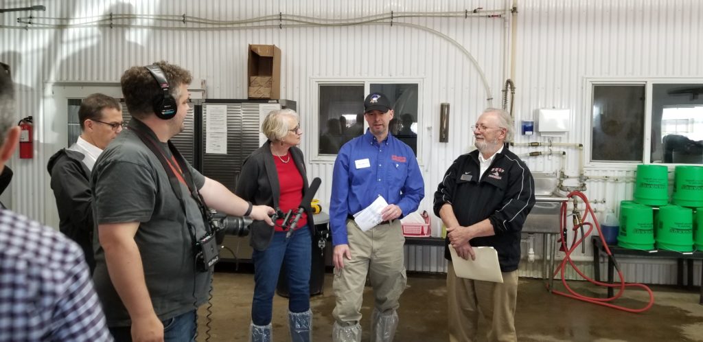 Photo of Kate VandenBosch, Dean of the College of Agricultural and Life Sciences at UW-Madison (left), Wayne Weber, Dean of the College of Business, Industry, Life Science and Agriculture at UW-Platteville (middle), and Dale Gallenberg, Dean of the College of Agriculture, Food and Environmental Sciences at UW-River Falls (right), discussing the impact of the $8.8 million Dairy Innovation Hub at a news conference at Four Cubs Farm in Grantsburg.