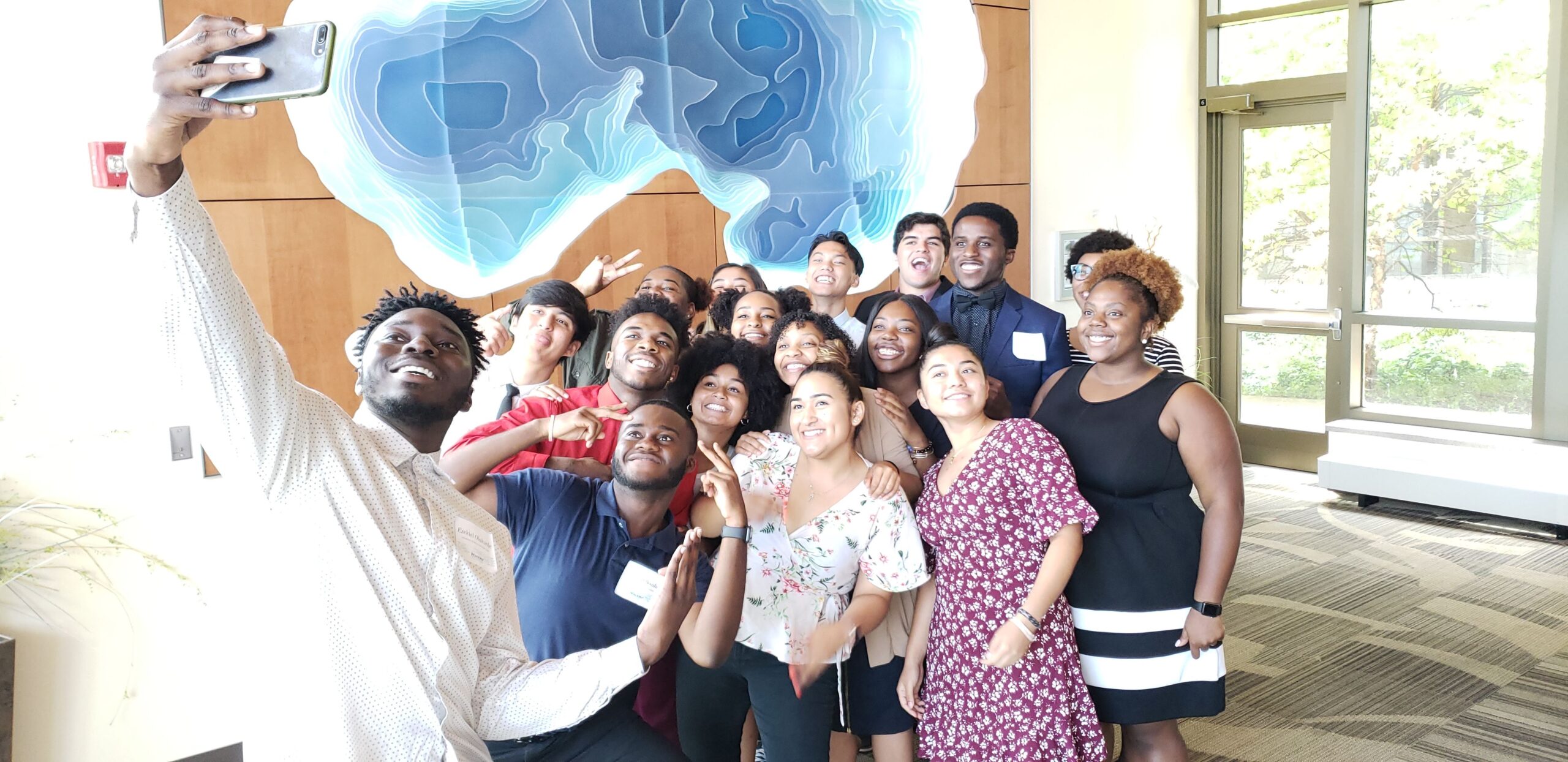 Photo of WiscAMP students from Beloit College, UW-Eau Claire, UW-La Crosse, UW-Madison, UW-Milwaukee, UW-River Falls, and UW-Whitewater capturing their smiles on the last day of the 2019 Excel Summer Program. Photograph by Denise Thomas.