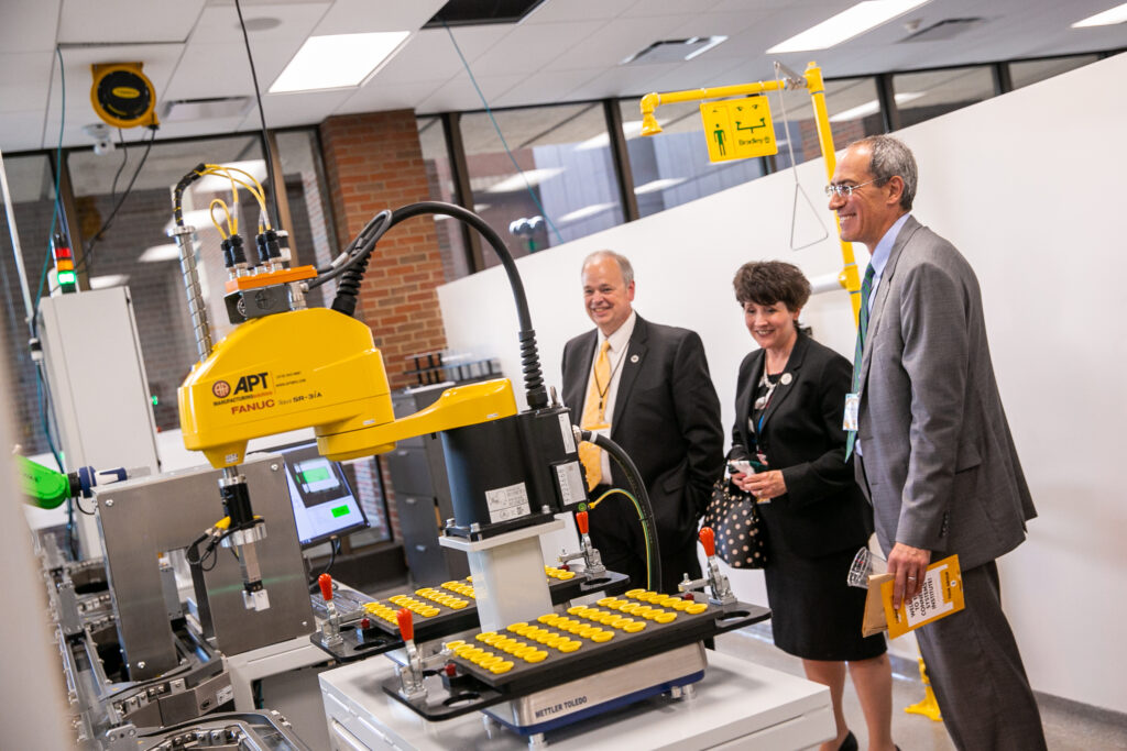 Photo of Chancellors Schmidt (UW-Eau Claire), Ford (UW-Parkside), and Alexander (UW-Green Bay) touring UW-Milwaukee's Connected Systems Institute, June 3, 2021