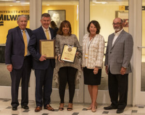 Photo of Regent Eve Hall accepting a resolution of appreciation (from left) President Thompson, Regent Petersen, Regent Hall, Regent Klein, and Regent Emeritus Falbo