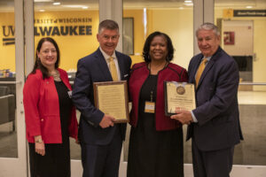 Photo of Regent Carolyn Stanford Taylor accepting a resolution of appreciation (from left) Regent Walsh, Regent Petersen, Regent Stanford Taylor, and President Thompson