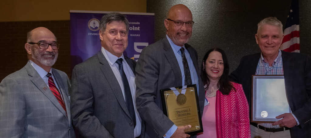 Photo of UW-Platteville Chancellor Shields accepting resolution of appreciation, pictured with Interim President Falbo, Regent President Manydeeds, Regent Vice President Walsh, and Regent Robert Atwell