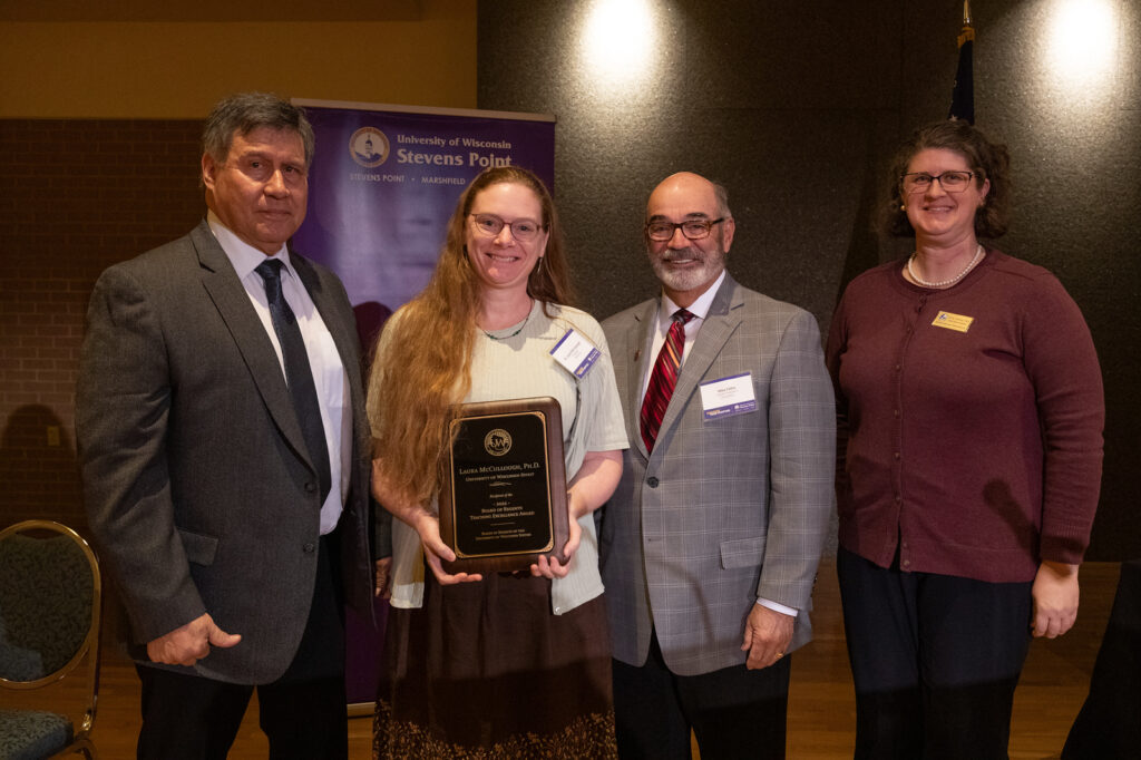 Photo of Dr. Laura McCullough with (from left) Regent President Edmund Manydeeds III, Interim President Michael J. Falbo, and Regent Jill Underly