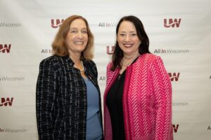 Photo of newly elected Regent President Karen Walsh (right) and Regent Vice President Amy Bogost posing for a photo together at the Board of Regents meeting held in the Zelazo Center for the Performing Arts at UW-Milwaukee on Friday, June 10, 2022. <em>Photo Credit: Troye Fox, UWM</em>