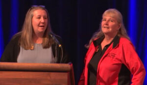 Photo of Missy Davis (left) and Jackie Bennett, accepting the Board of Regents 2022 University Staff Excellence Award on behalf of UW-River Falls Custodial Services